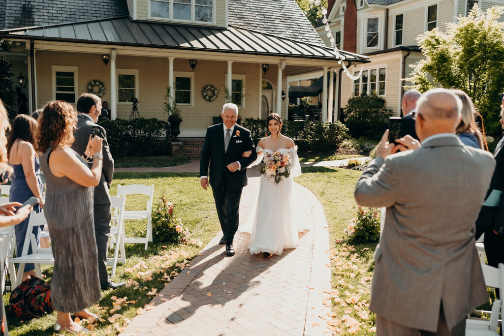 bride and groom during their ceremony bride walking down the aisle