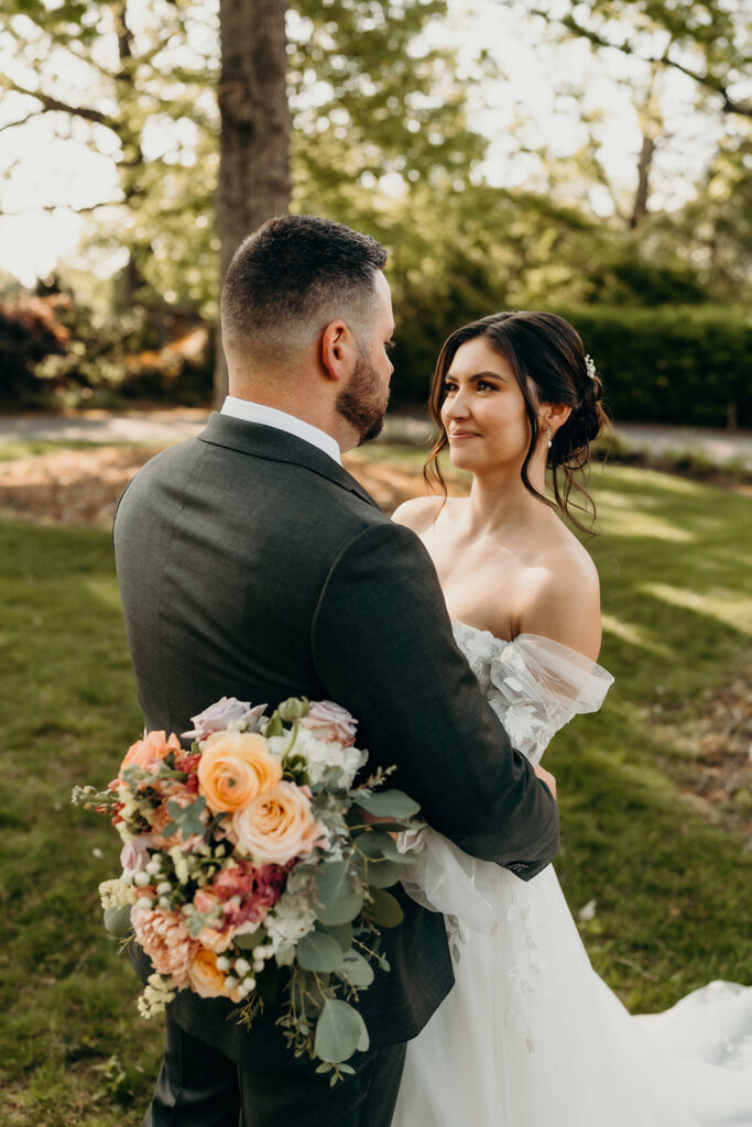 couple's portraits in the front lawn bride and groom looking into each others eyes