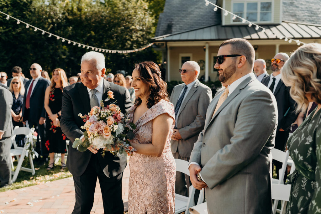 bride and groom during their ceremony while parents watch