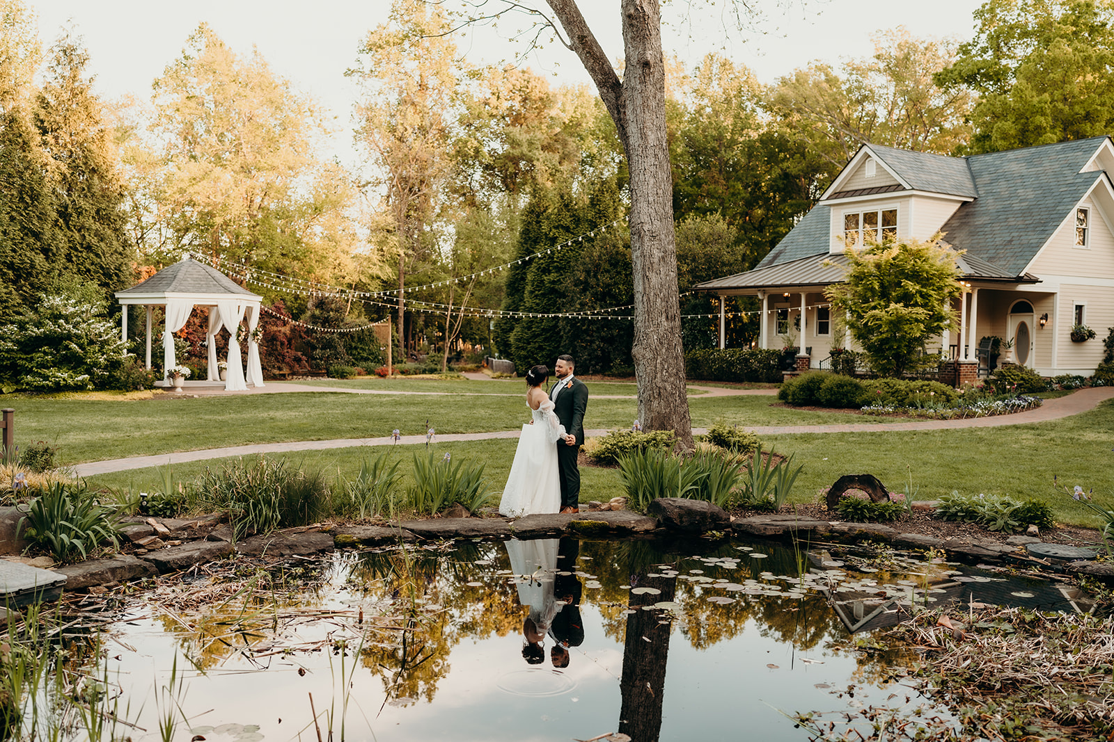 couple in front of the pond at golden hour sunset