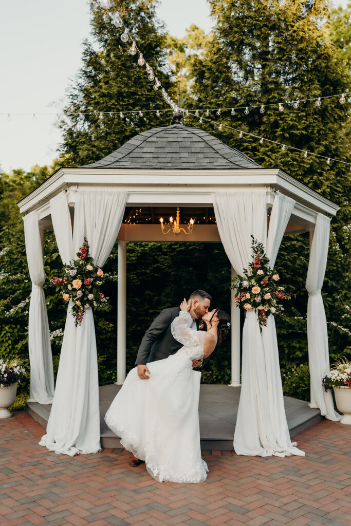 couple kissing in front of the gazebo