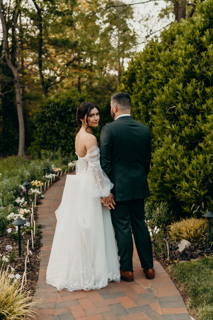 couple walking to reception in the barn on the pathway