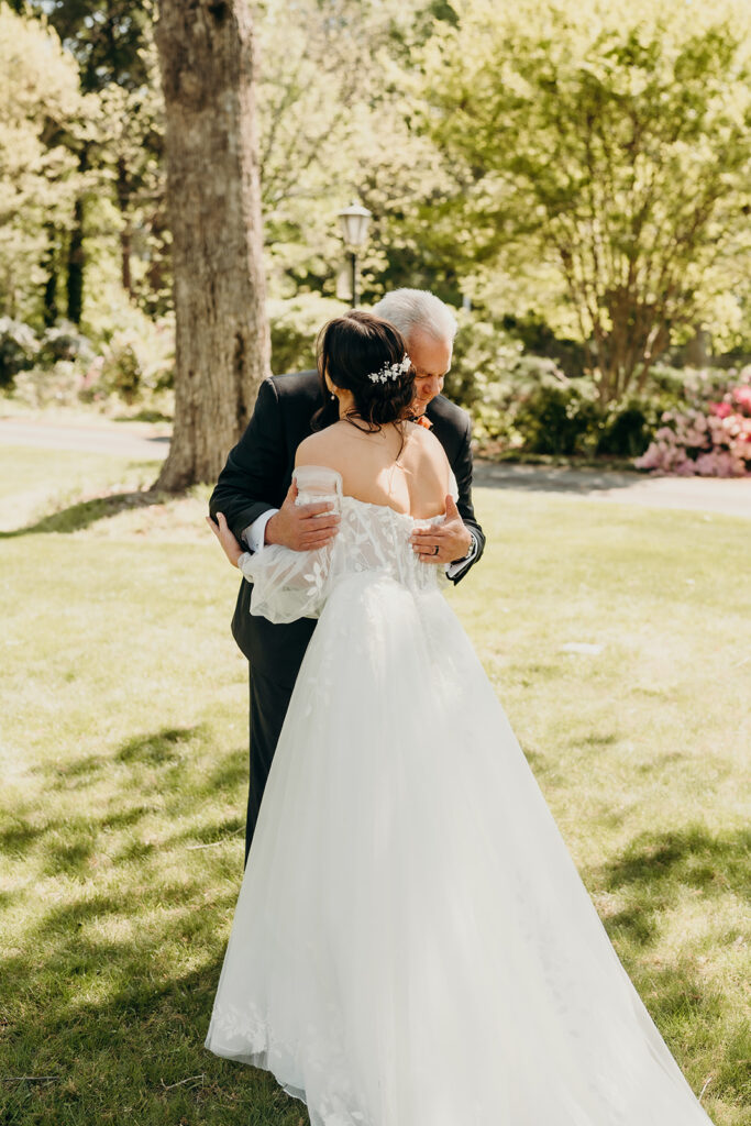bride and dad doing a first look in the front lawn