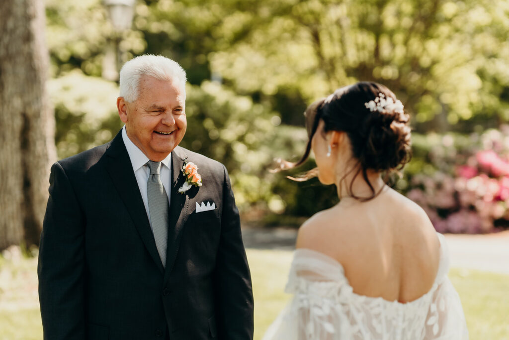 bride and dad doing a first look in the front lawn