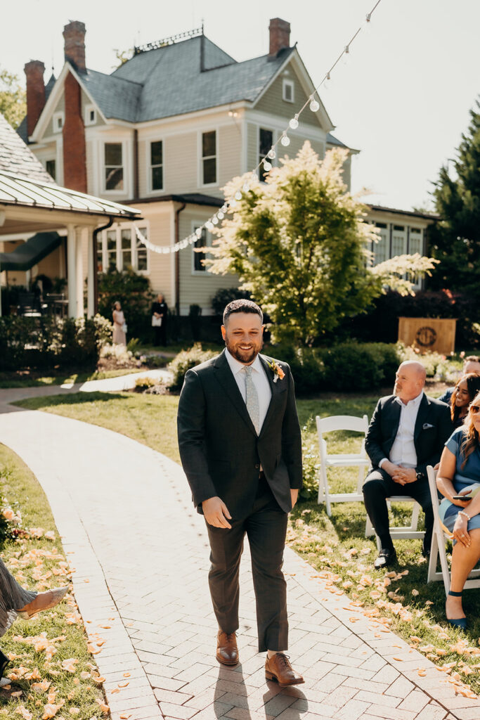 bride and groom during their ceremony groom walking down the aisle