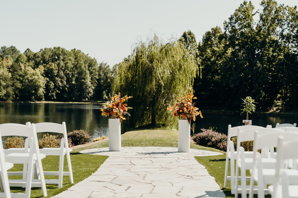 Wedding ceremony set up with pillar florals on the aisle