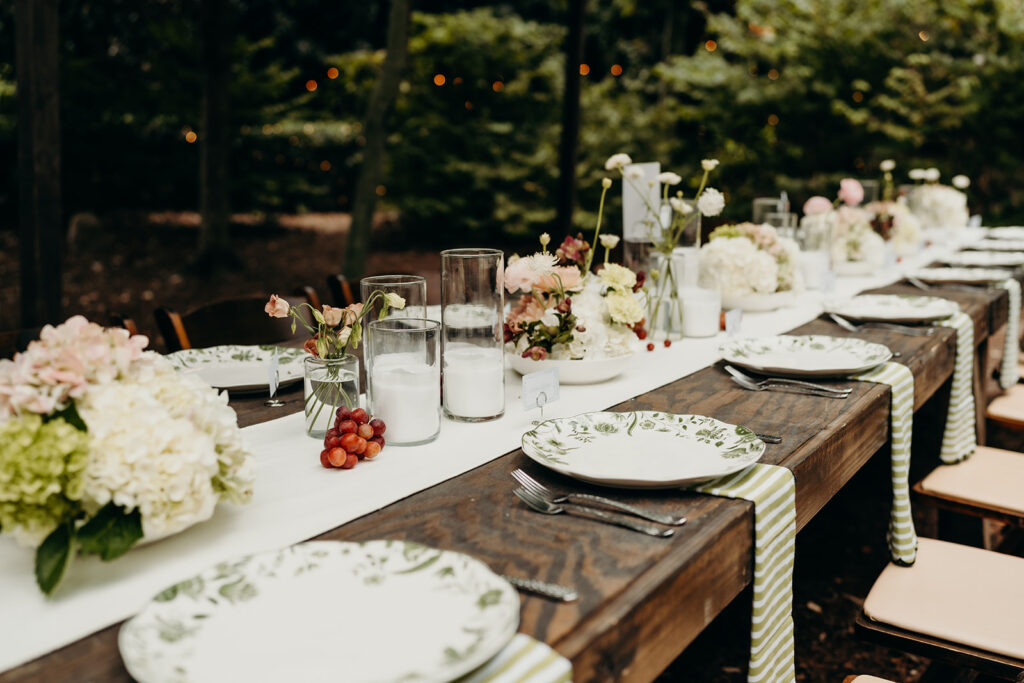 Wedding reception table with stripped linens and vintage plates