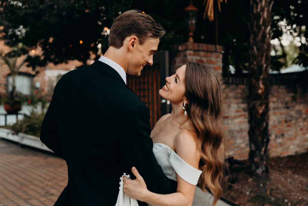 couple looking and each other while laughing and holding each other