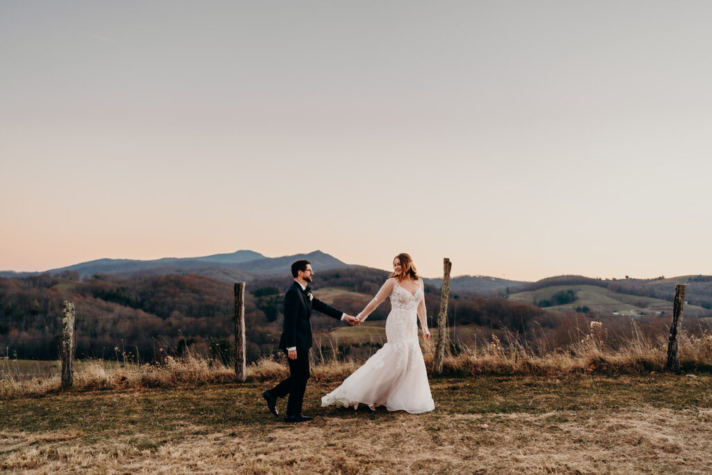 Couple walking up a hill together while they look at each other with joy