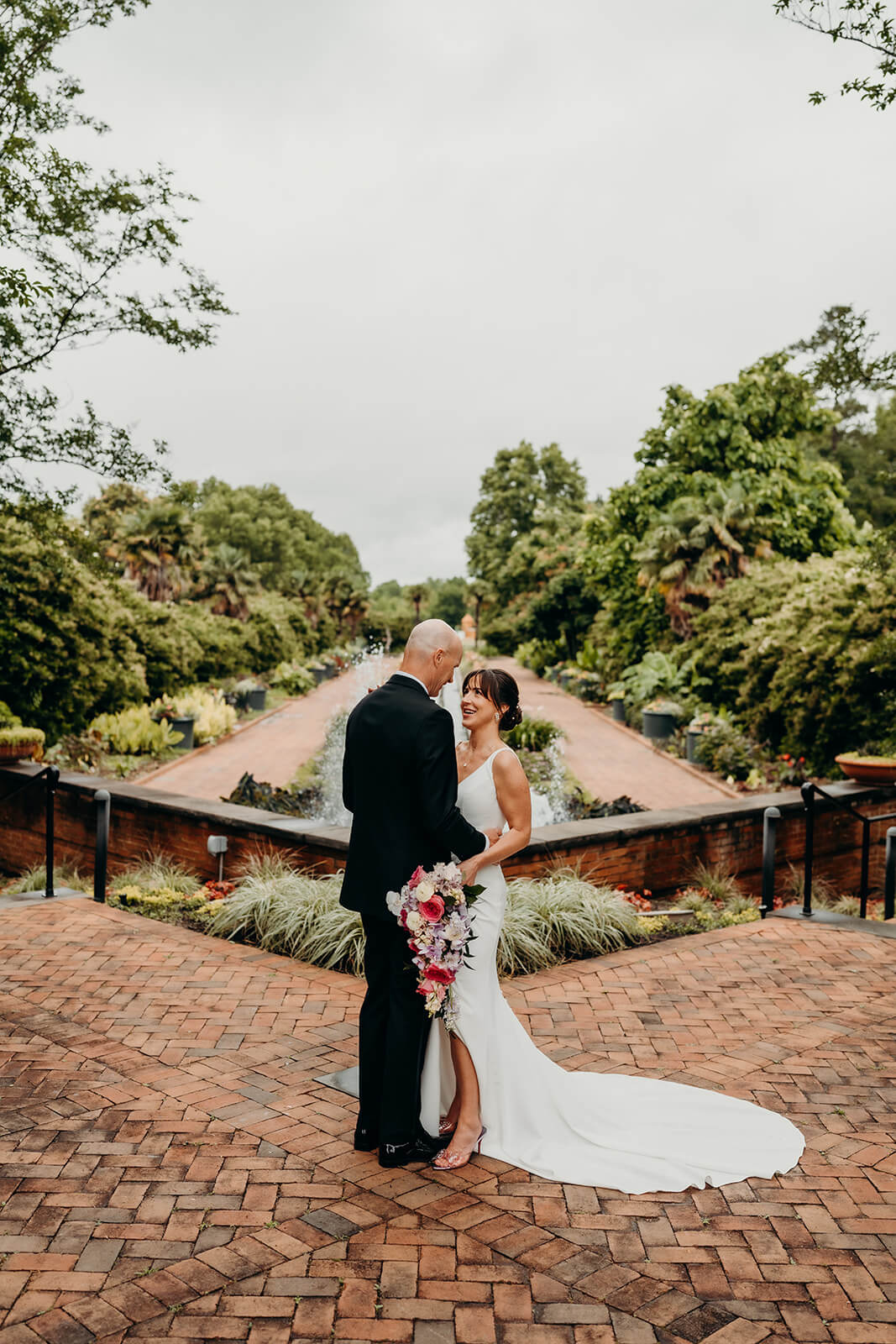 bride and groom couple's portraits bride and groom celebrating with family for a Daniel Stowe Botanical Garden Wedding