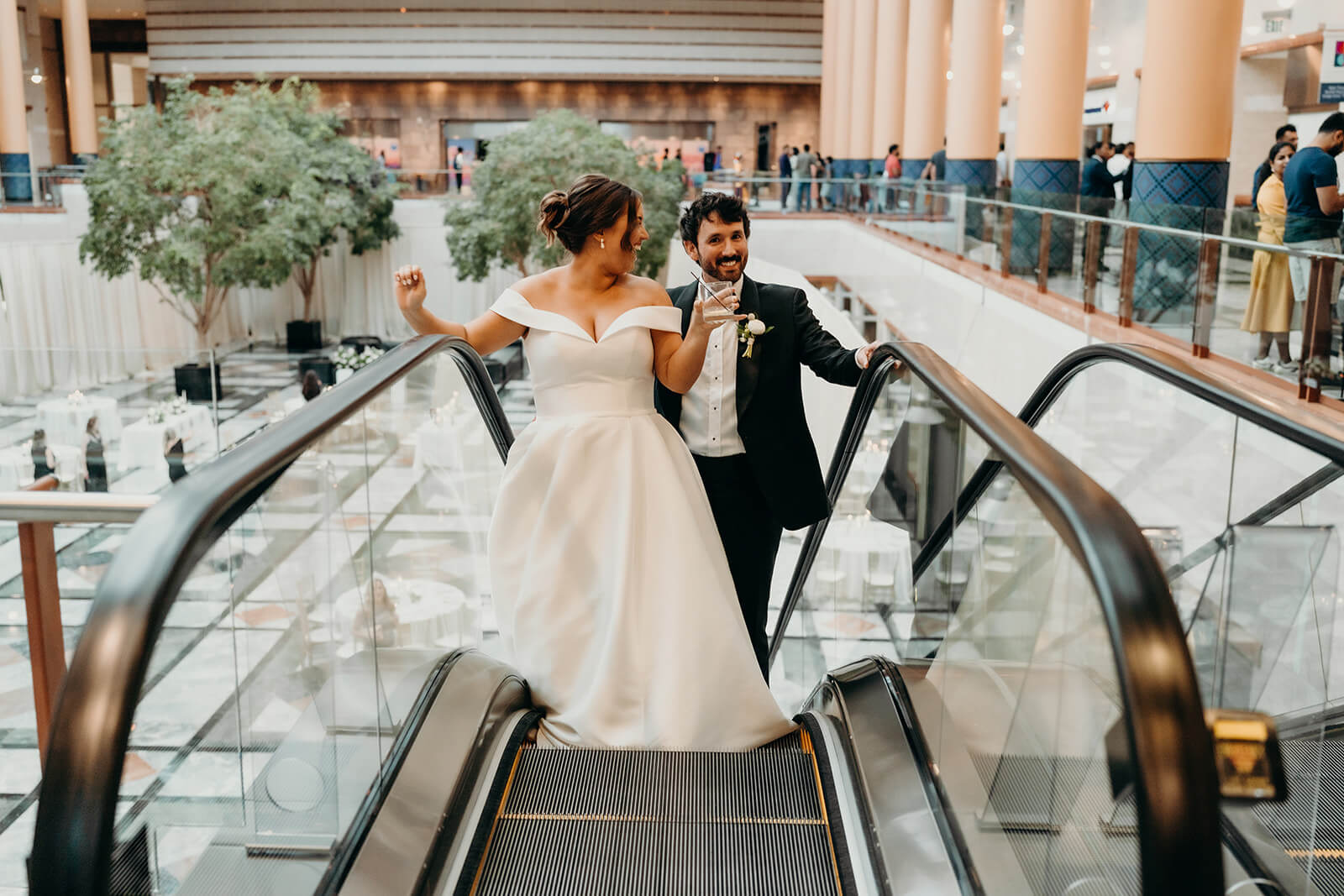 bride and groom riding escalator