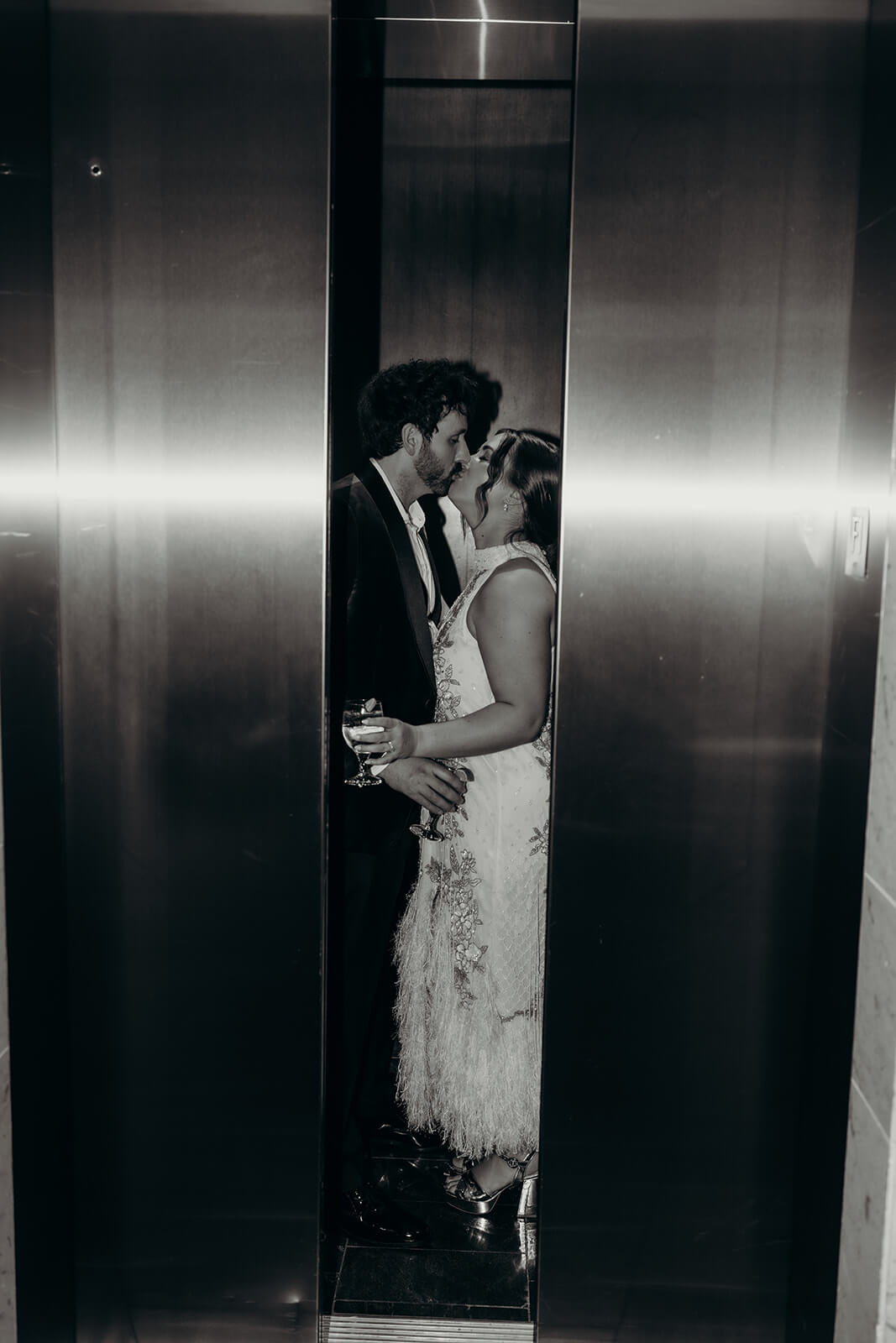 bride and groom in elevator at the end of the night