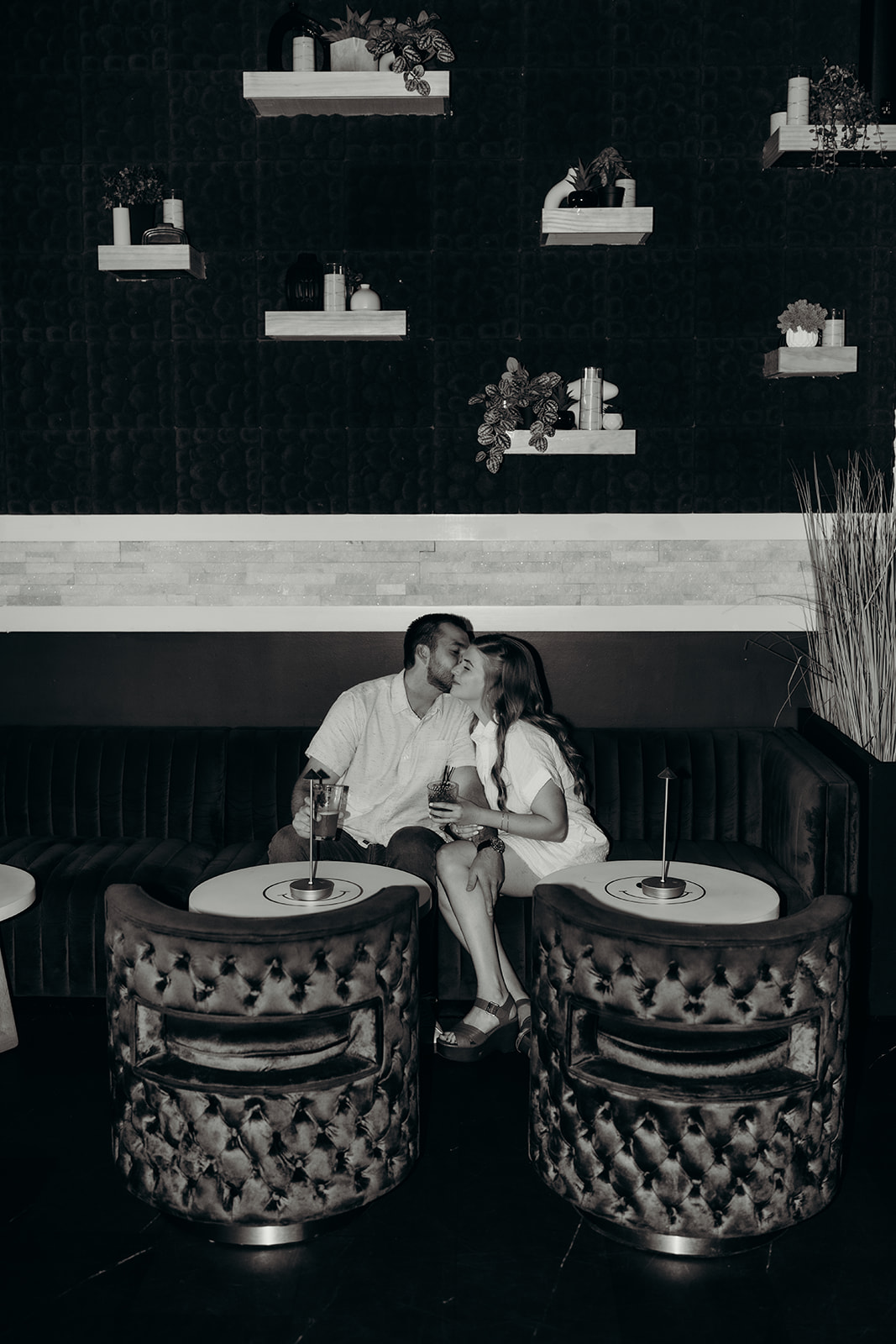 couple posing in front of bar at Must Be Nice in Charlotte