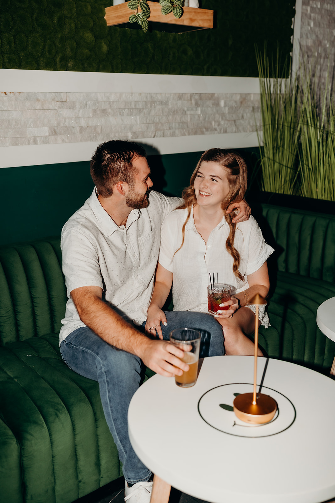 couple posing in front of bar at Must Be Nice in Charlotte