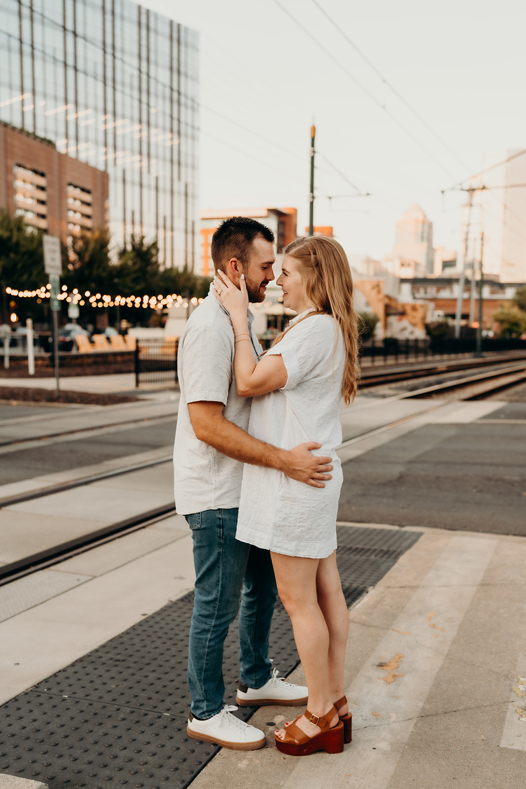 South End Charlotte Engagement couple with skyline in the background