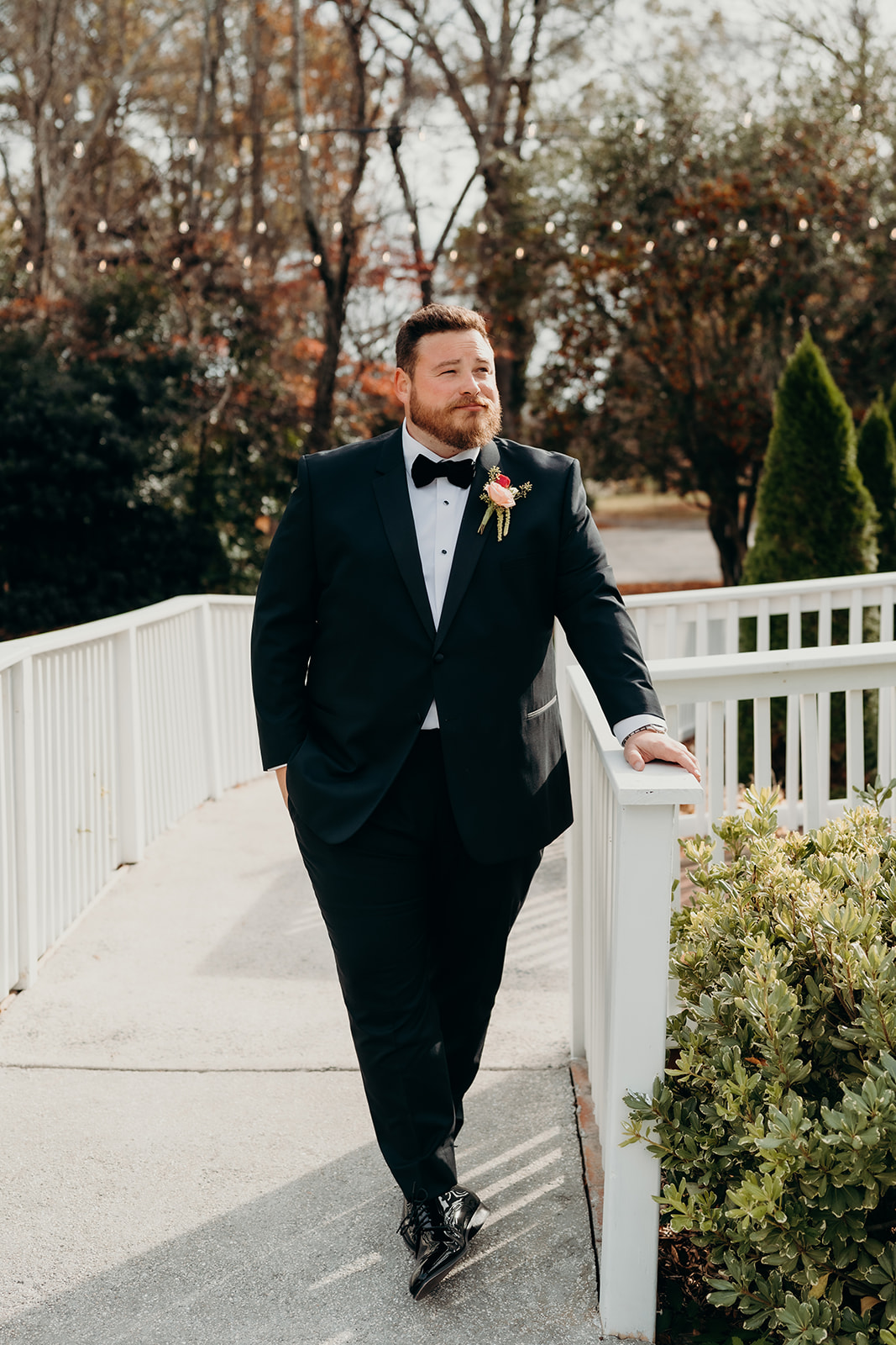 Groom leaning on railing