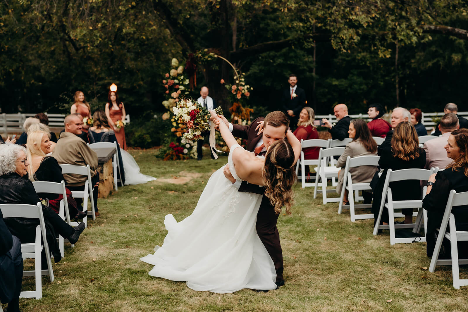 bride and groom dip down the aisle after their ceremony
