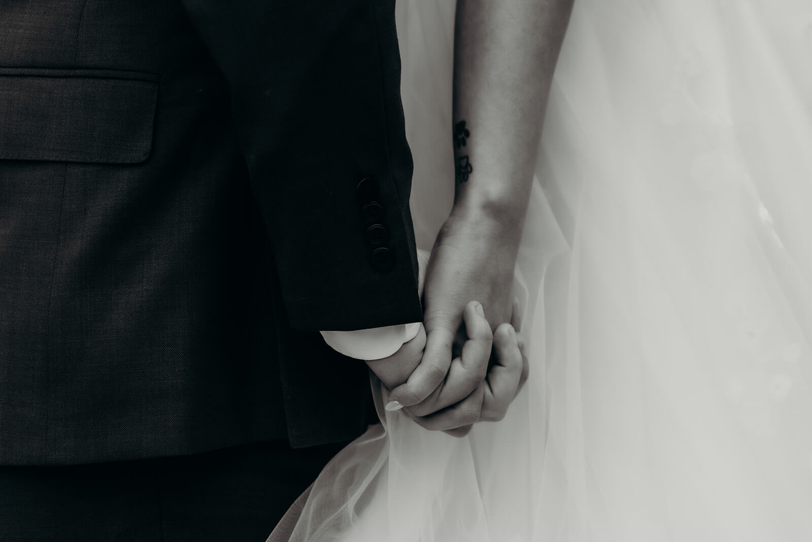 bride and groom holding hands during a blind first moment together before the ceremony