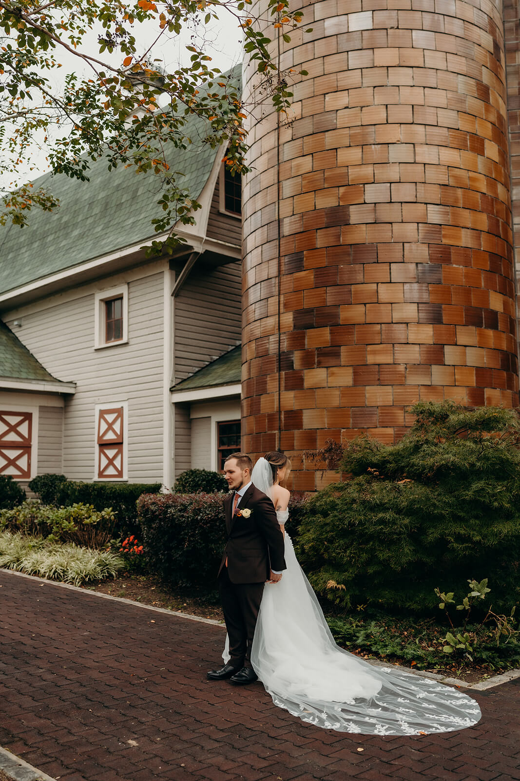 bride and groom holding hands during a blind first moment together before the ceremony at The Historic Wakefield Barn
