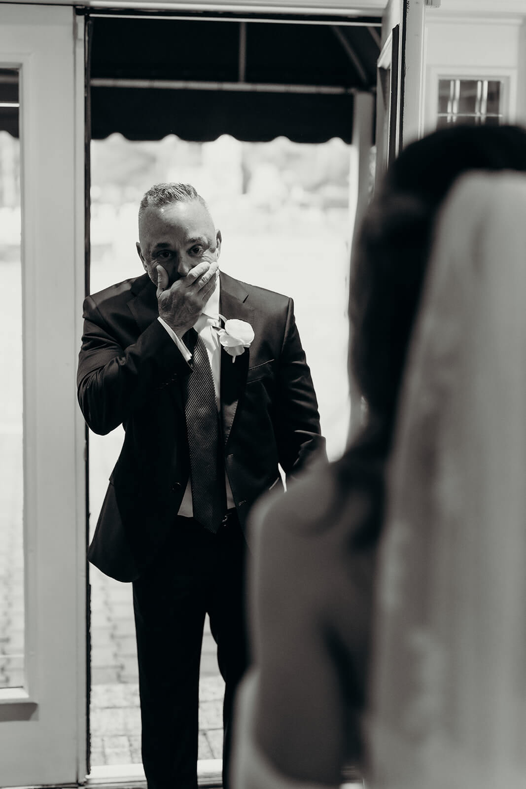 bride and dad first look moment inside the bridal suite