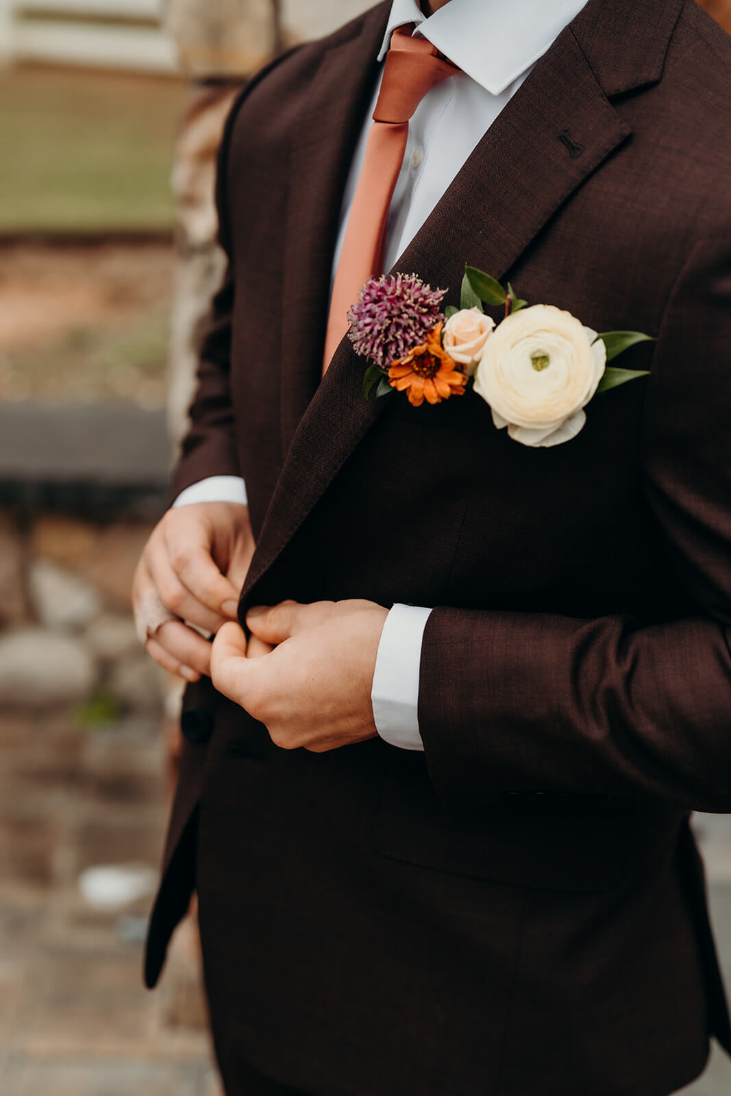 Groom buttoning up suit