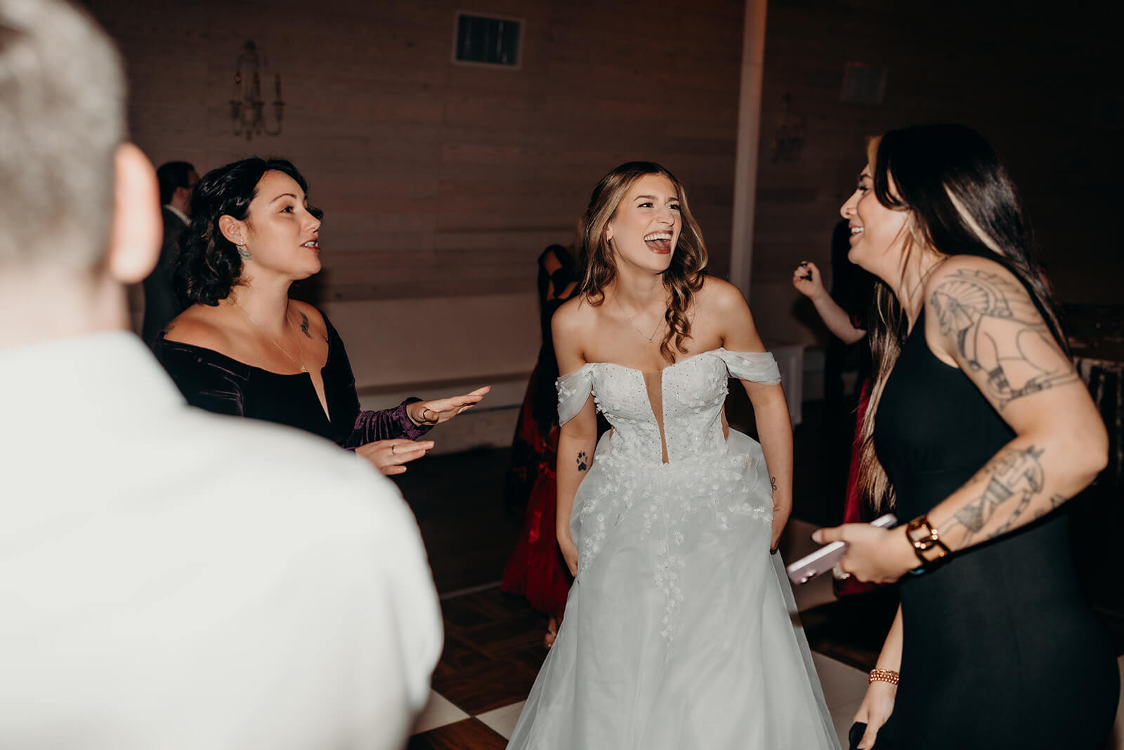 bride dancing with her friends on the dance floor
