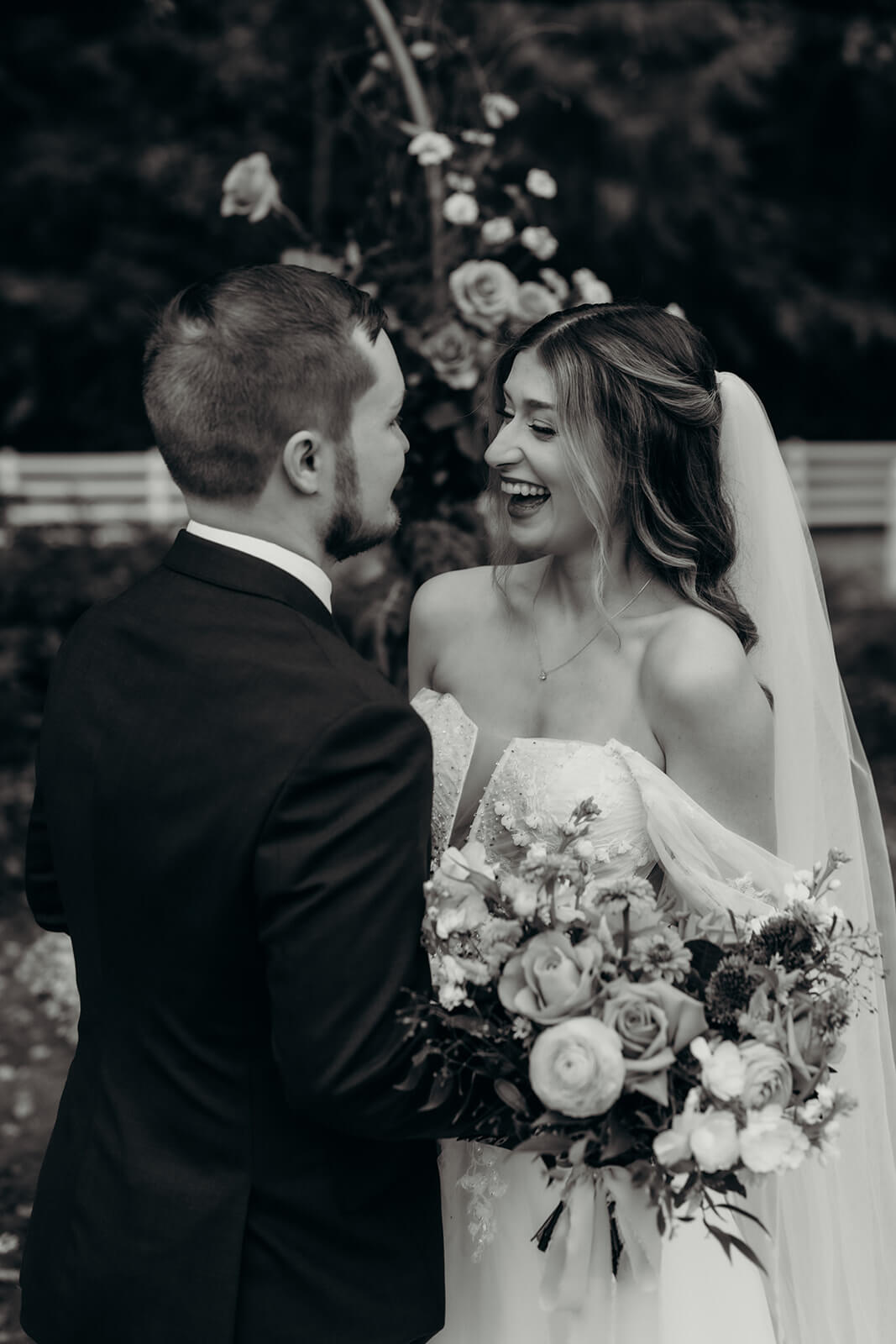 bride and groom laughing black and white photo