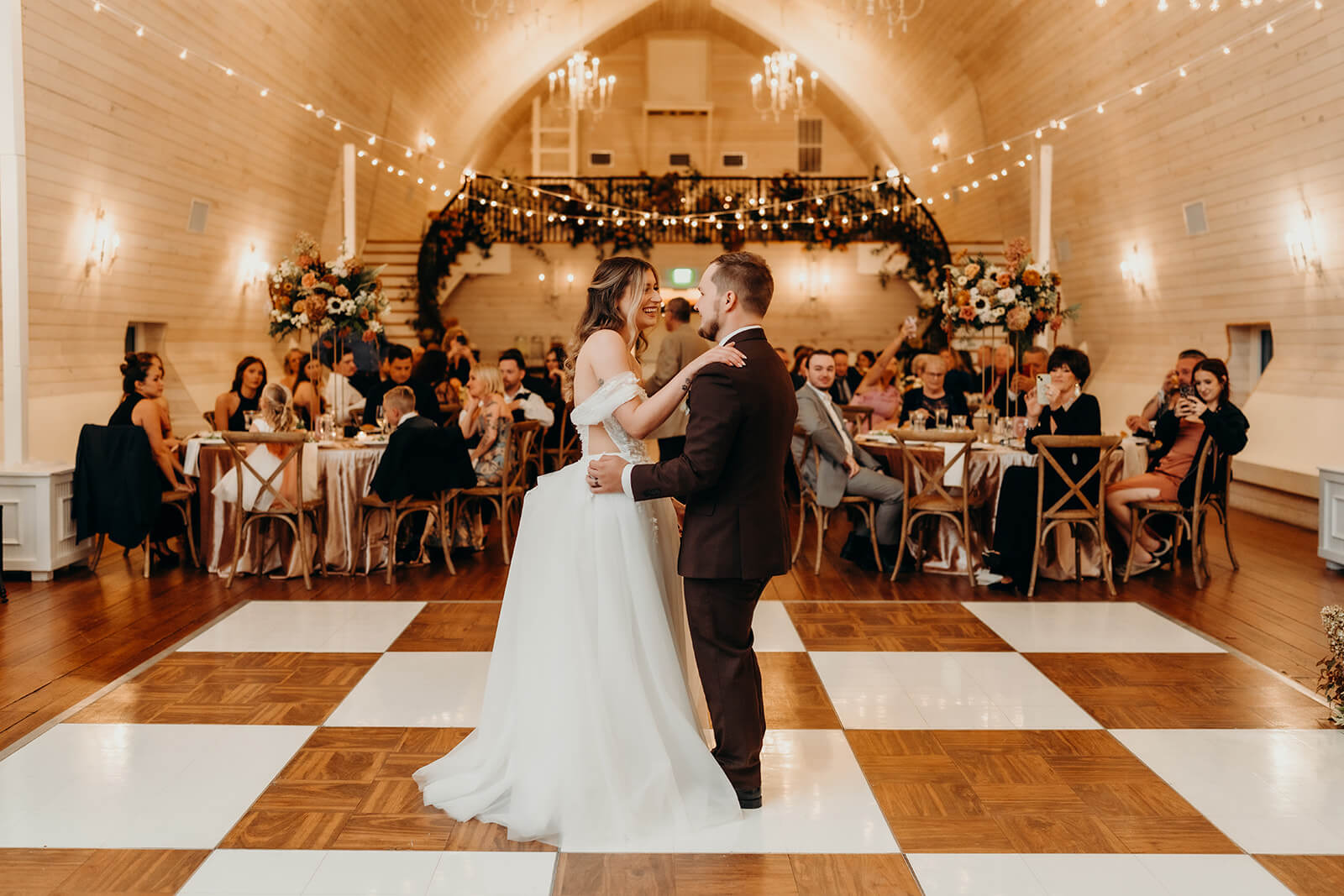 bride and groom first dance together at bride and groom portraits at The Historic Wakefield Barn