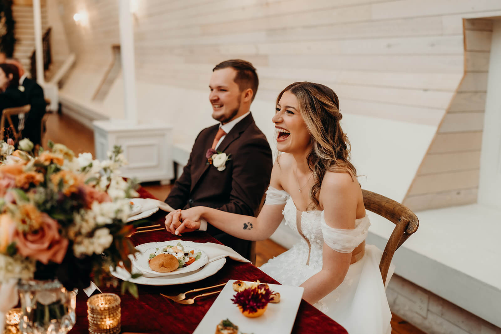 bride and groom laughing during toasts