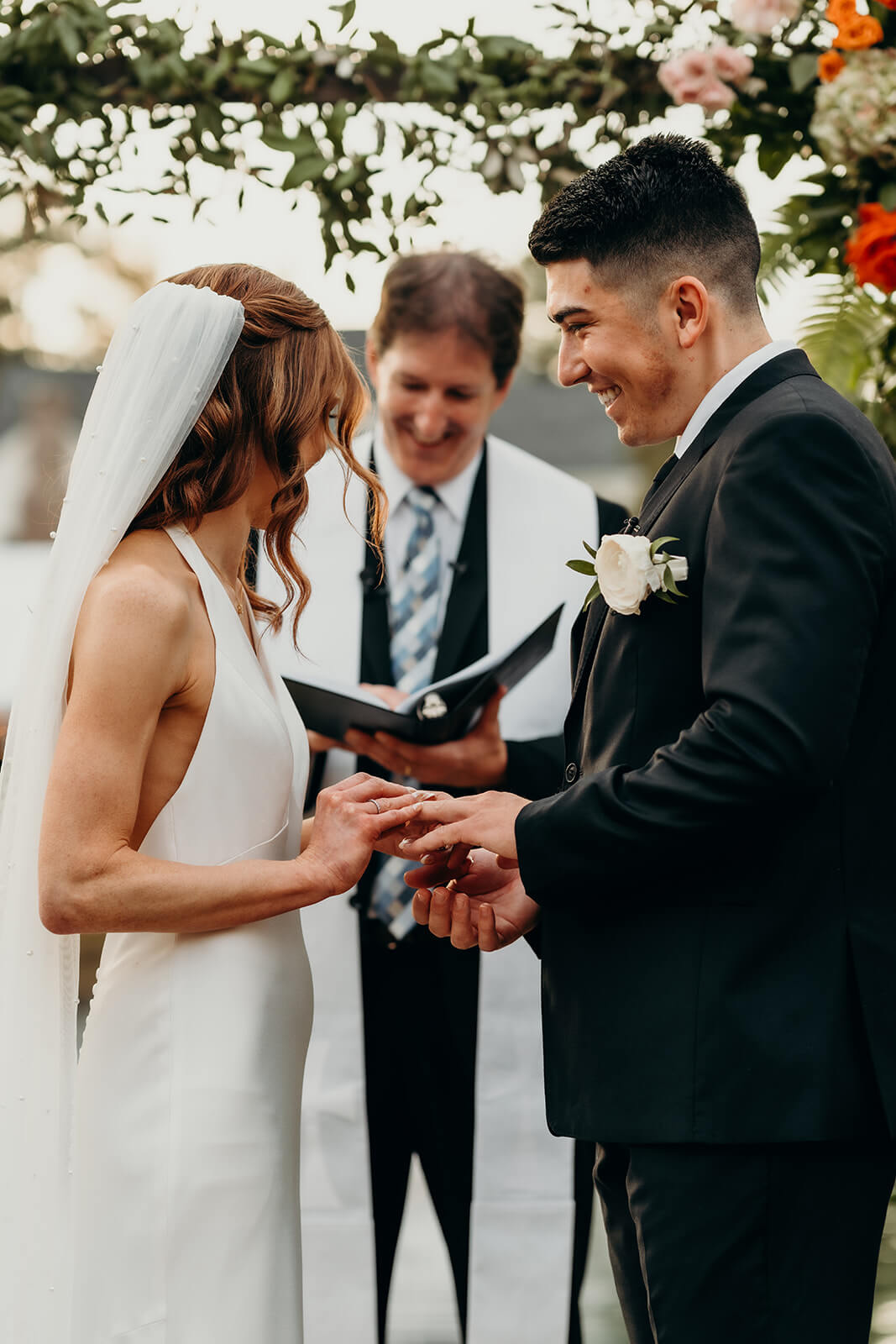 bride and groom exchanging rings