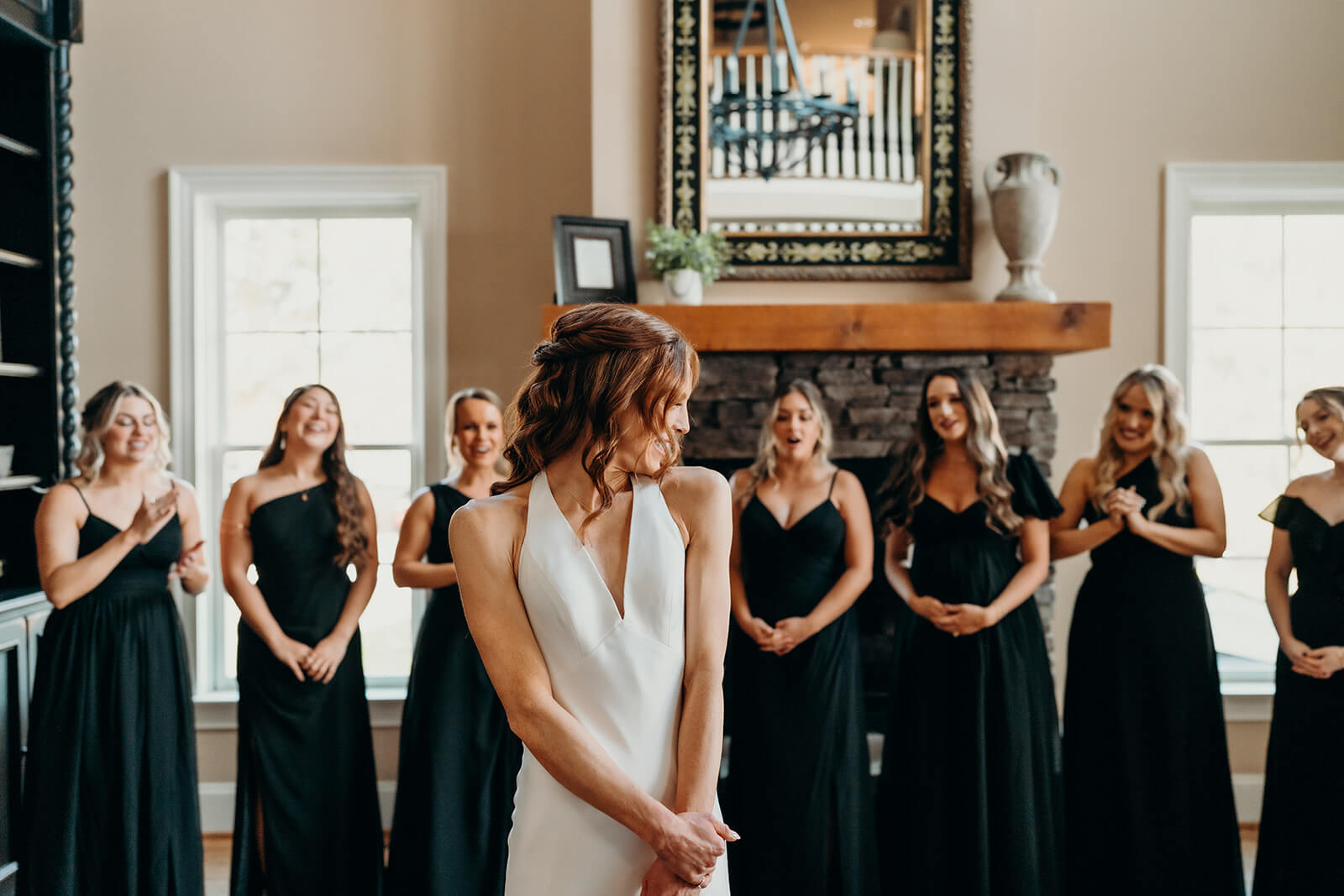 bride showing her bridesmaids her dress for the first time