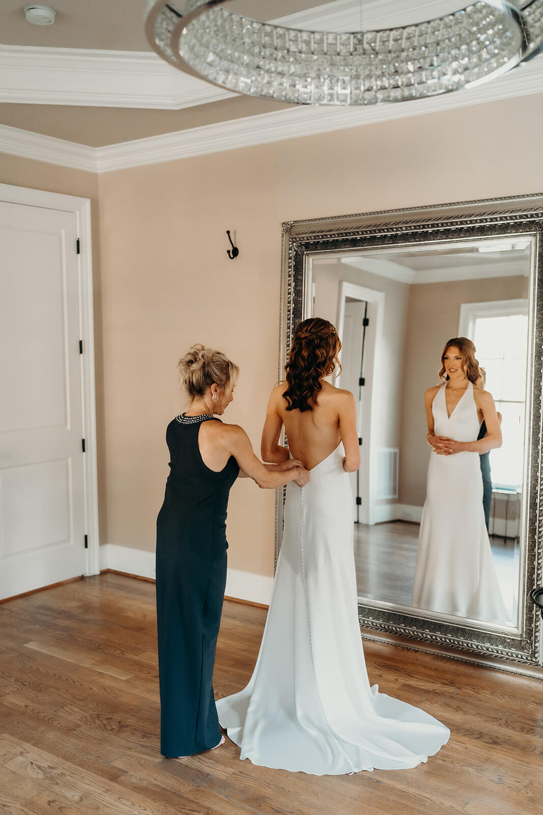 bride and mom getting ready in the bridal suite at bride and dad first look moment on the porch at The Oaks at Salem