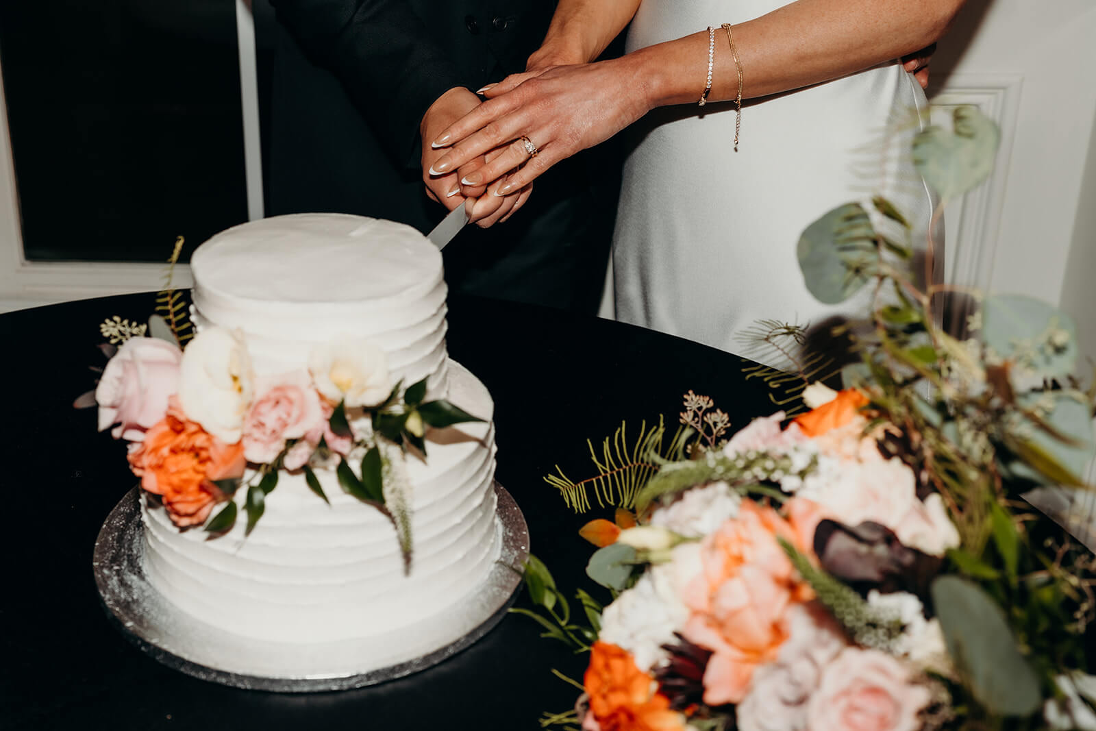 bride and groom cutting the cake