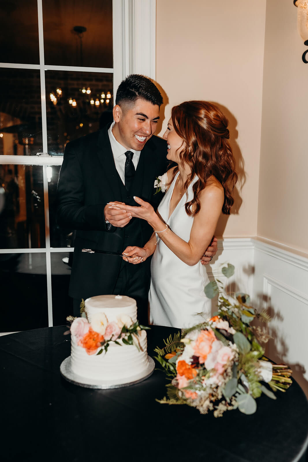 bride and groom cutting the cake