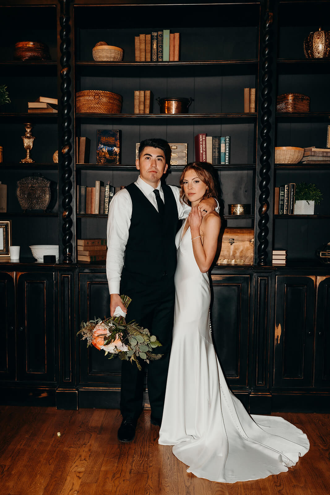 bride and groom couples portraits in front of the black bookcase at The Oaks at Salem