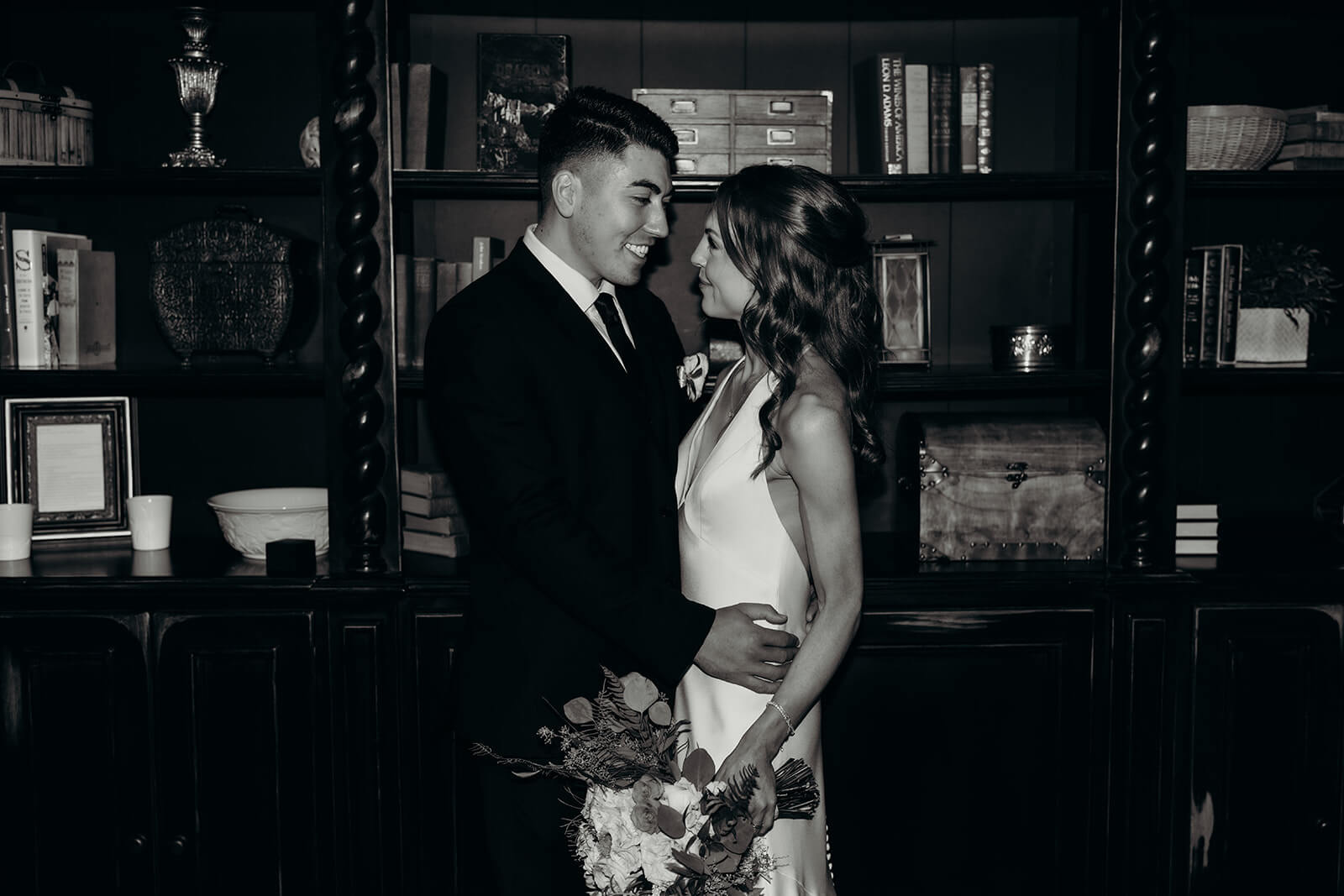 bride and groom couples portraits in front of the black bookcase at The Oaks at Salem