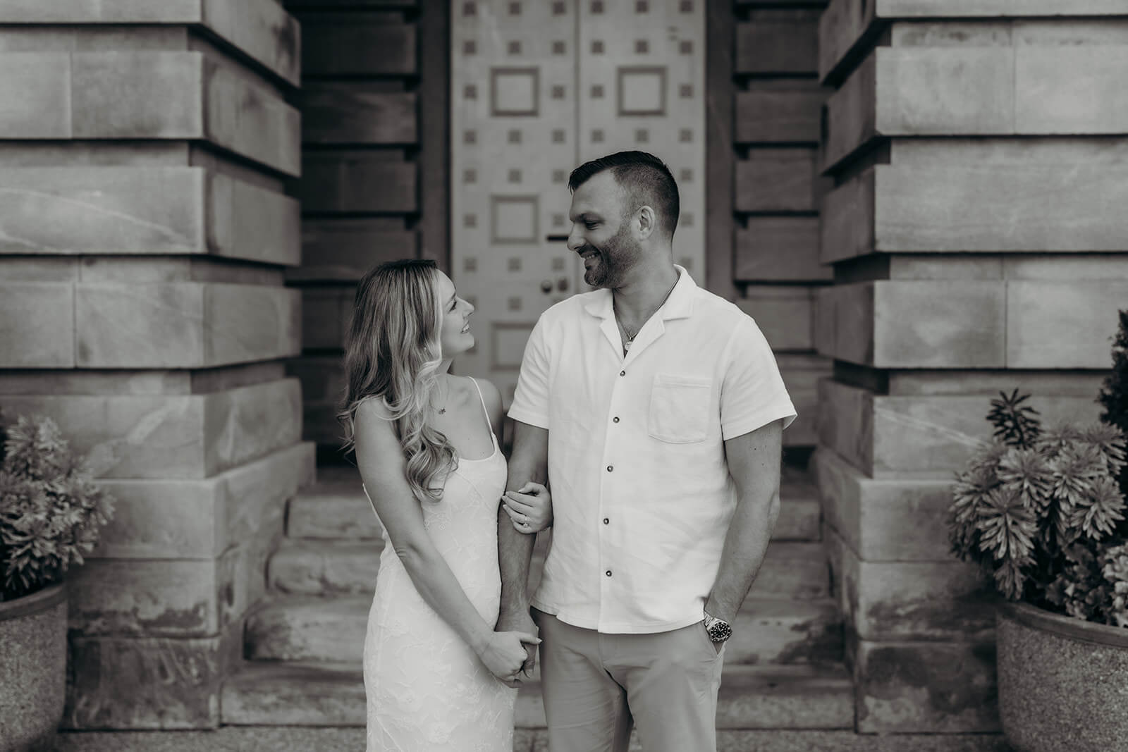 couple holding hands in front of the Capitol building downtown raleigh engagement photos