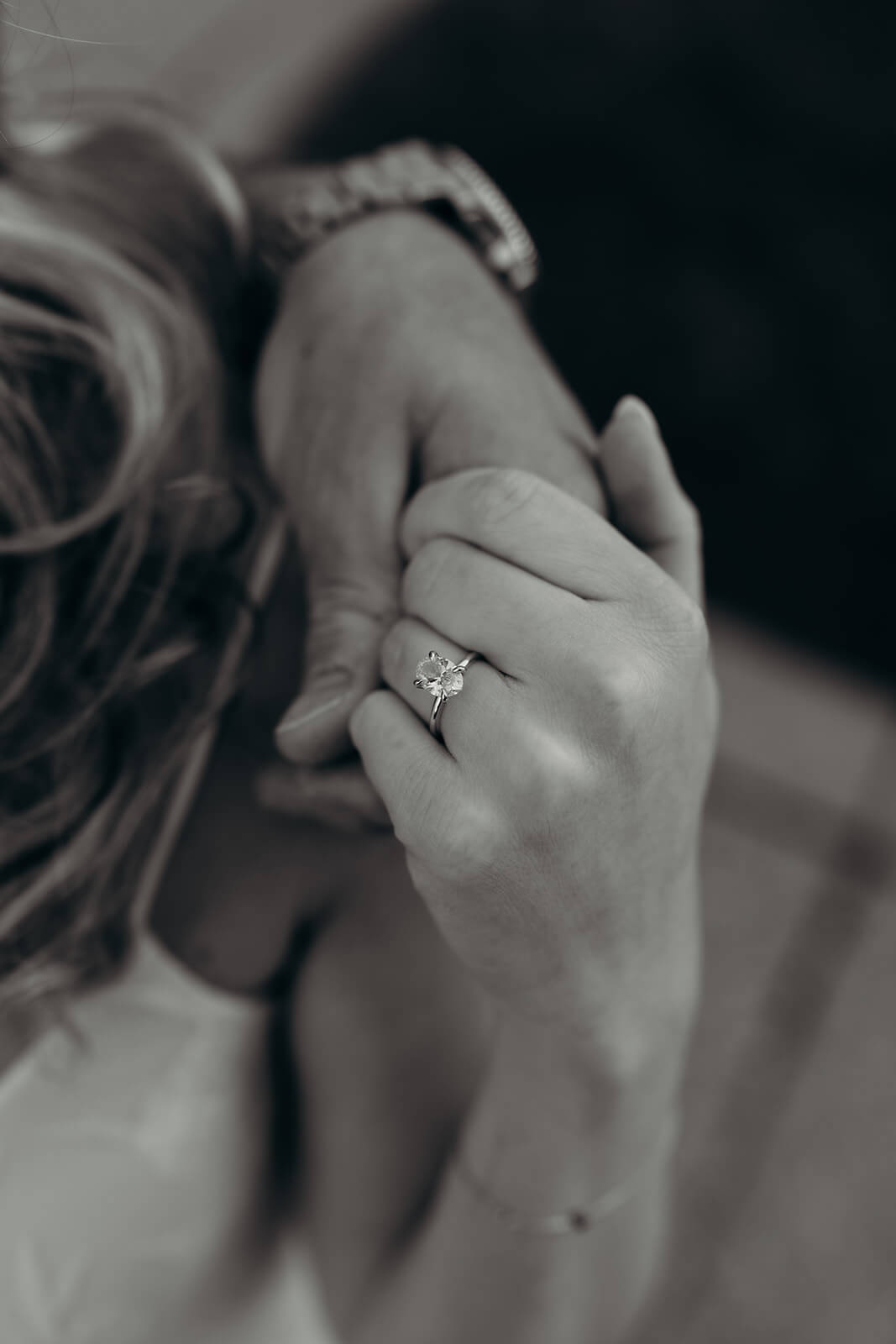 close up black and white photo of the girls engagement ring