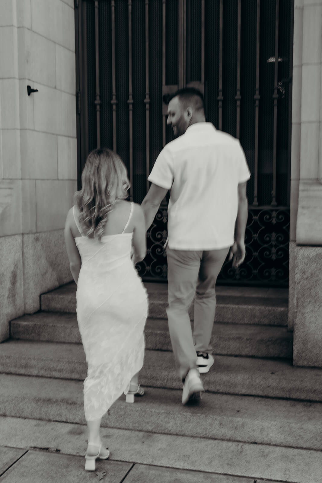 couple walking up the stairs blurry black and white photo
