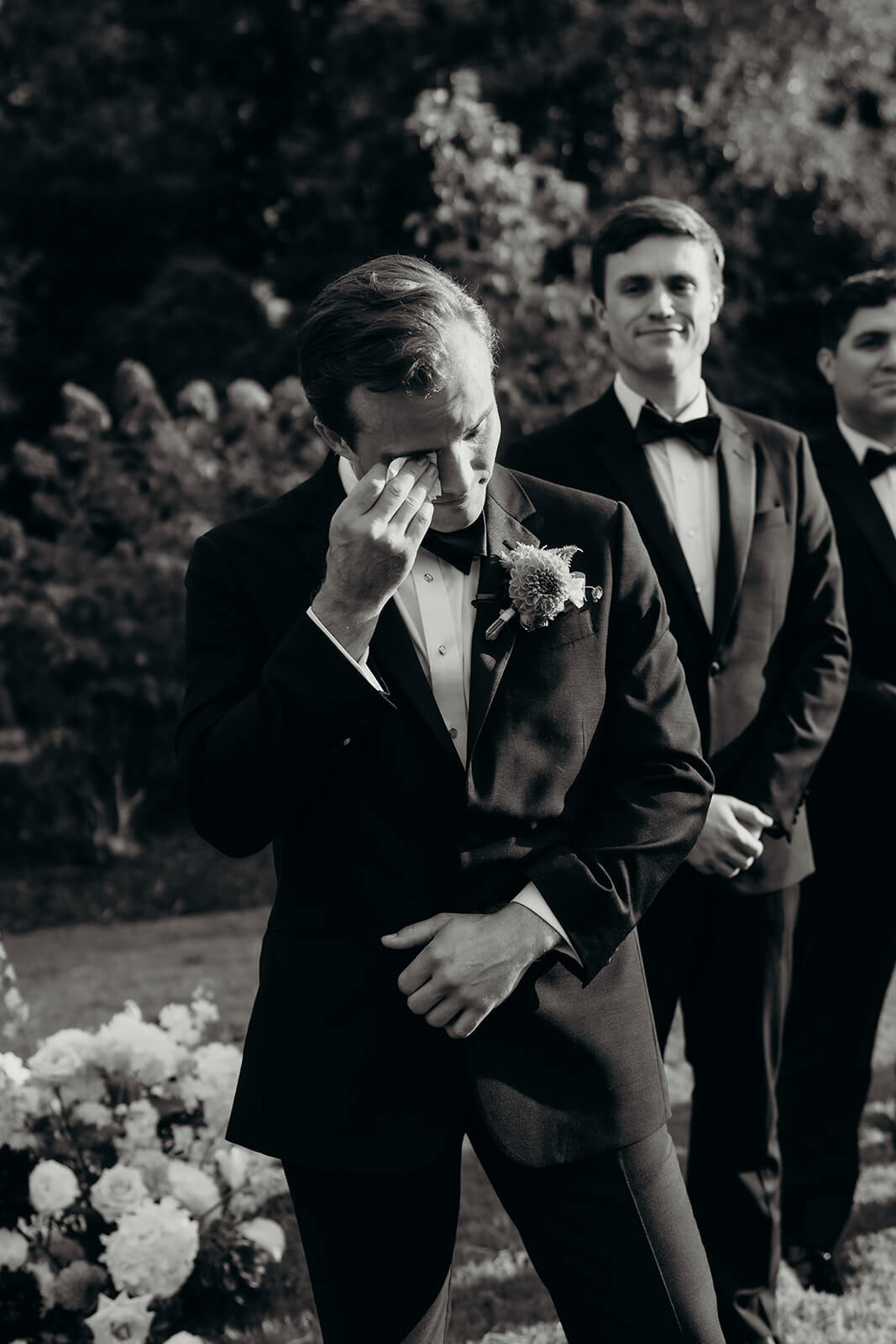 groom crying as bride walks down the aisle