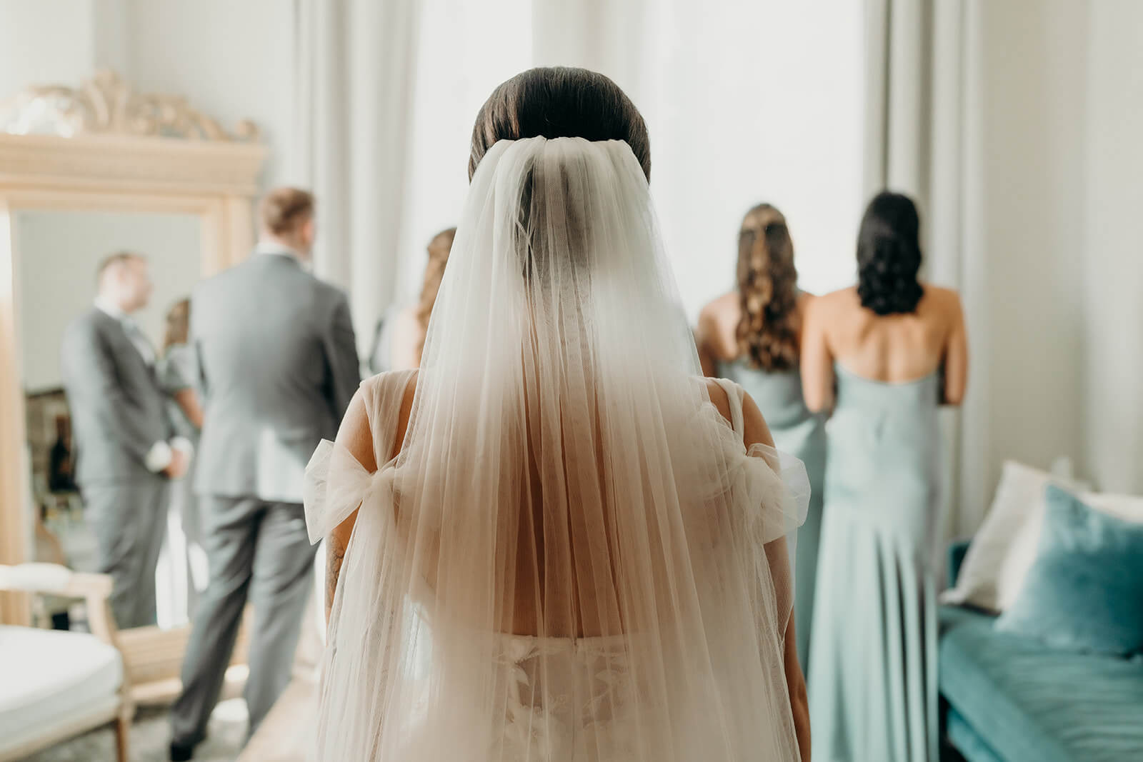 bride doing a first look with her wedding party right before they see her for the first time