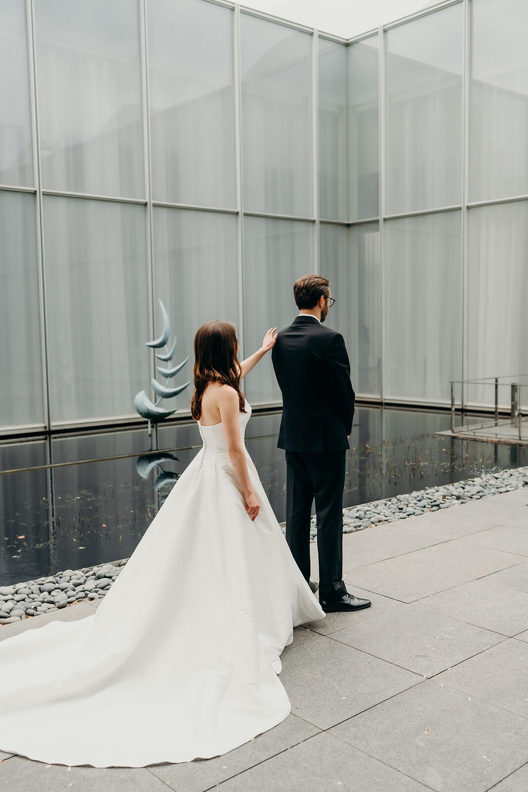 bride and groom first look moment outside of NCMA Wedding Photos