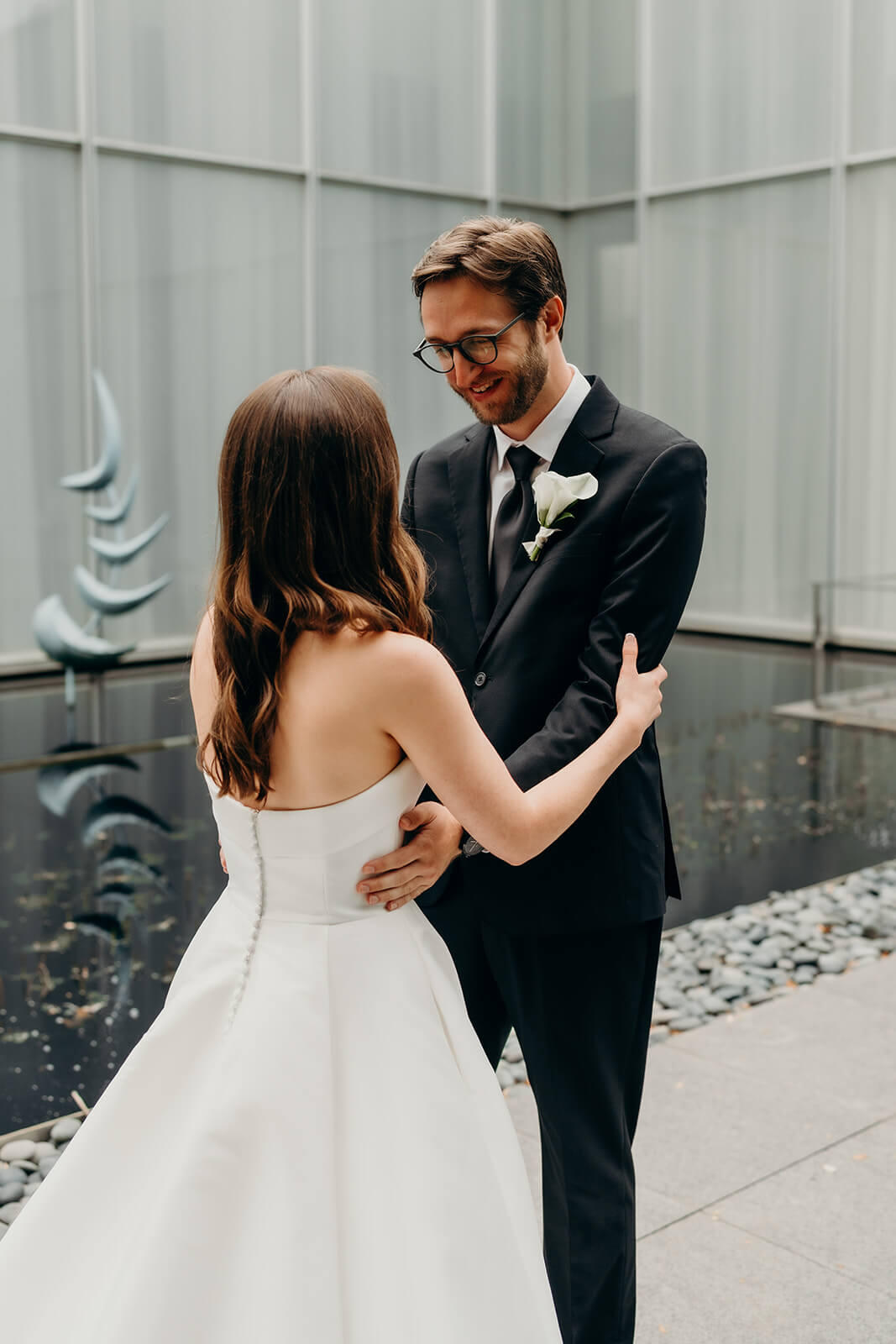 bride and groom first look moment outside of NCMA Wedding Photos