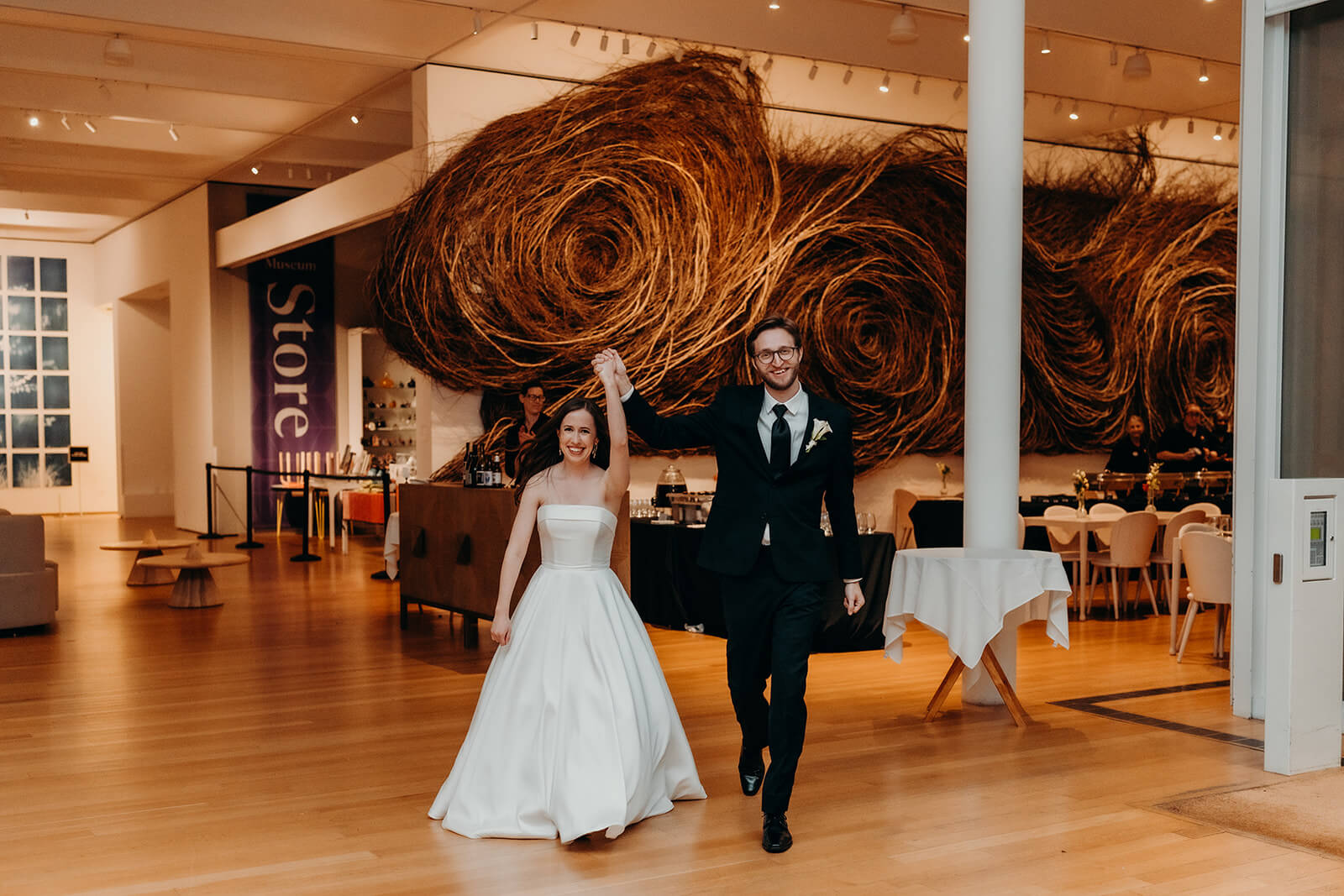 bride and groom entering their wedding reception at NCMA wedding photos