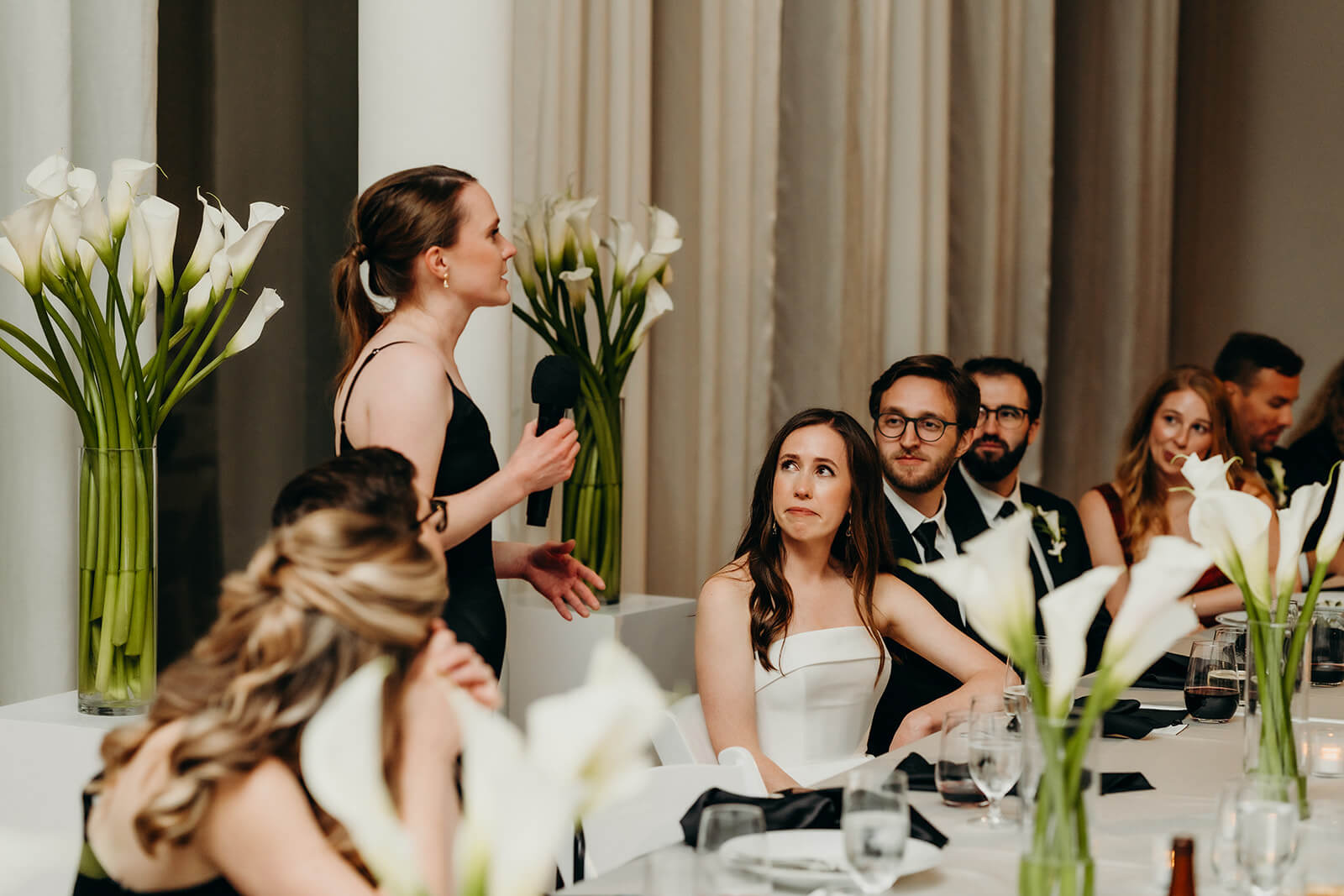 bride and groom laughing while listening to toasts NCMA wedding photos