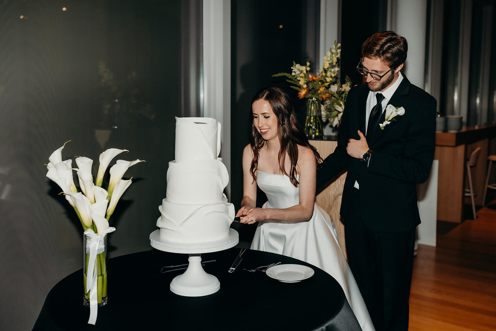 NCMA wedding photos of bride and groom cutting their cake 