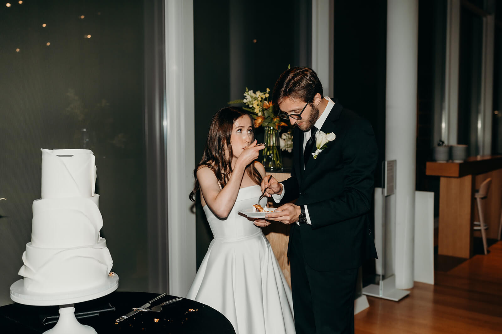 NCMA wedding photos of bride and groom cutting their cake 