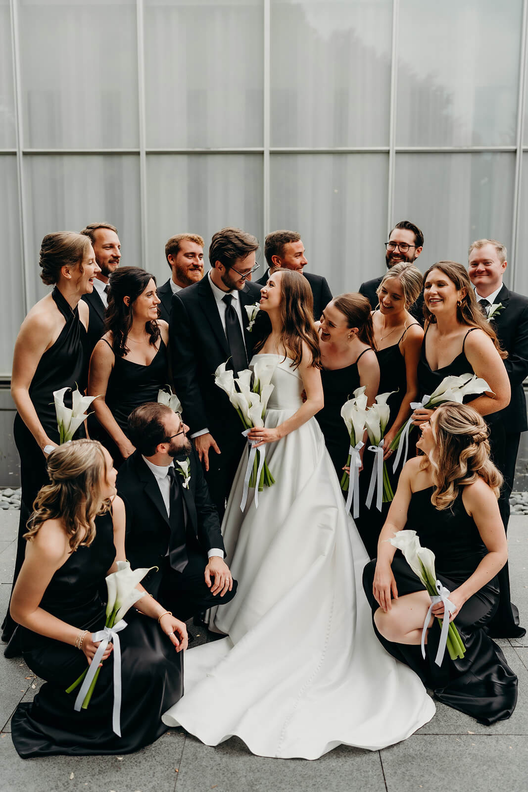 NCMA wedding photos of bride and groom with their wedding party celebrating around them